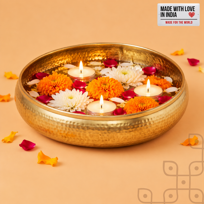 brass-finish hammered urli with flowers, petals and three floating tealights, styled for Diwali