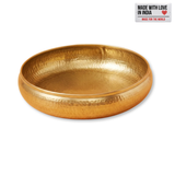 Hand-hammered brass-finish urli bowl showing its empty interior against a white background.
