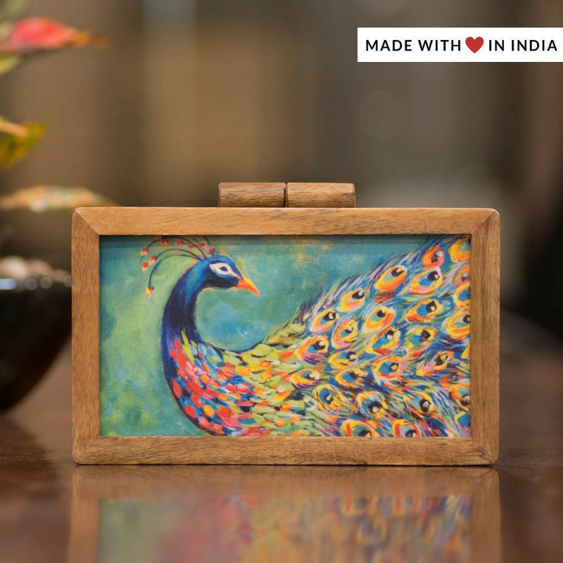 https://madewithloveinindia.co.uk/cdn/shop/products/pihu-painted-peacock-silk-designer-clutch-bag-in-mango-wood-collectiontitle-323355_800x.jpg?v=1621204540