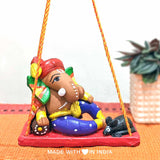 Vishvamukha — Handpainted Terracotta Ganesha Statue on a Swing